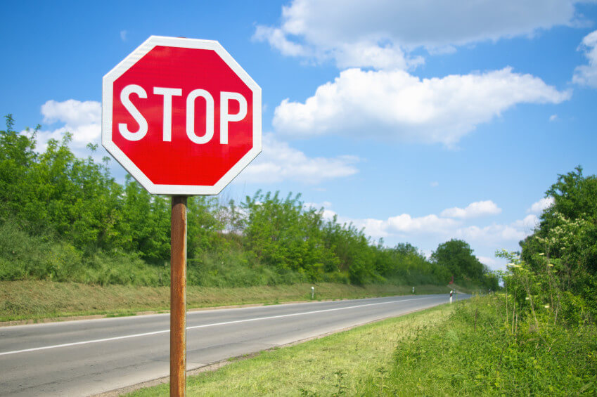 Team of engineers reviewing plans for road sign installation
